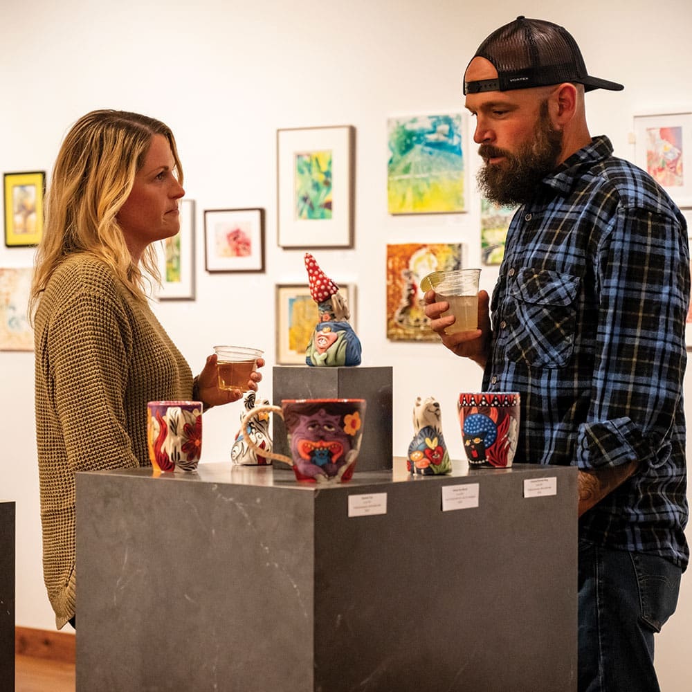 People discussing art in a gallery